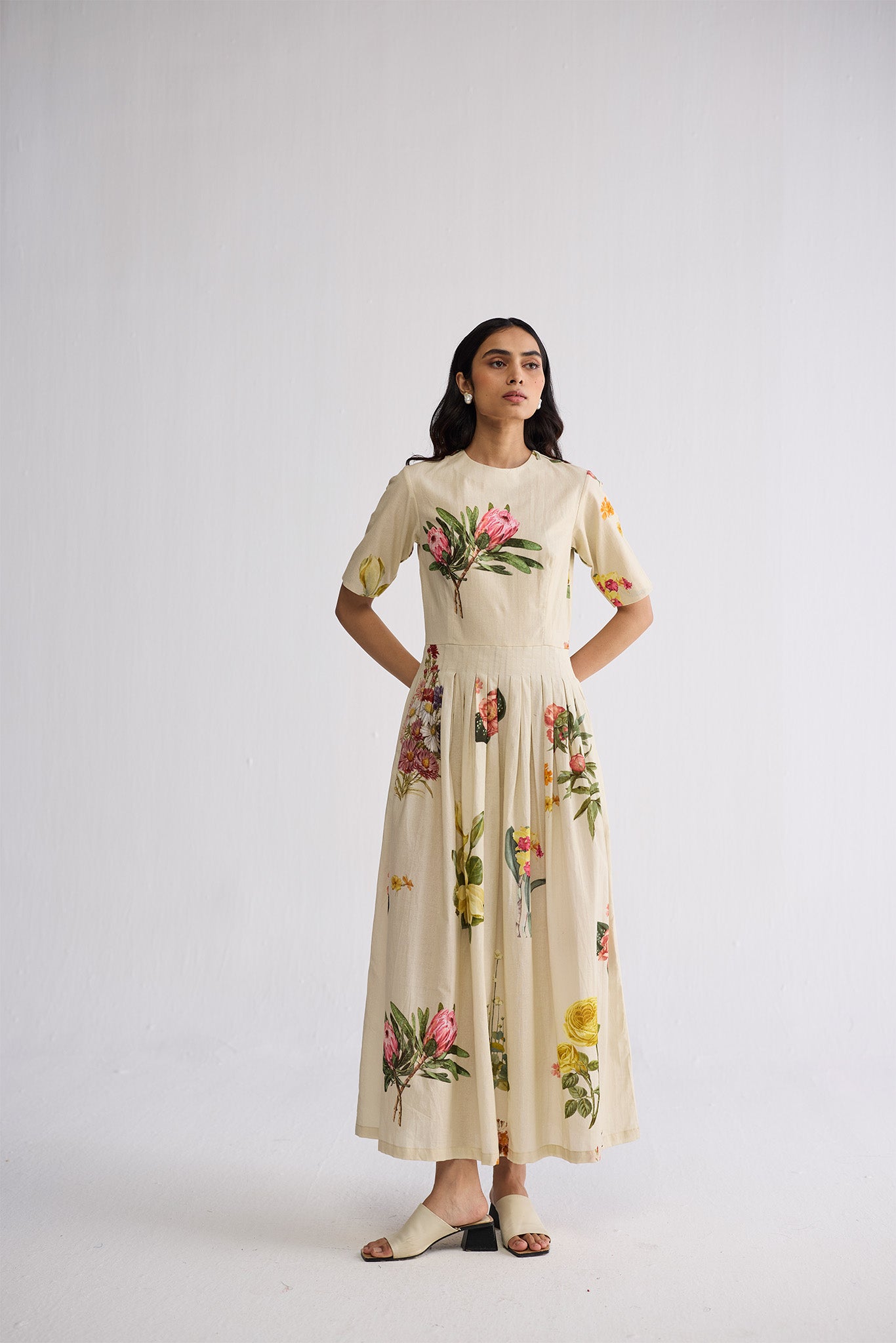 half pleated dress Avril gown, A box pleated dress features a type of pleating where fabric is folded into square-shaped pleats, giving the dress a structured and voluminous look. , A half-shoulder gown, also known as